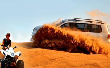 As the sun sets over the desert horizon, an evening desert safari begins. A 4x4 vehicle is ready for an adventure, with the warm hues of twilight casting a magical glow on the sand dunes. Tourists prepare for an exciting journey, with the promise of a memorable evening in the desert.